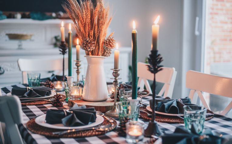 dining room table set with fall decor and candles